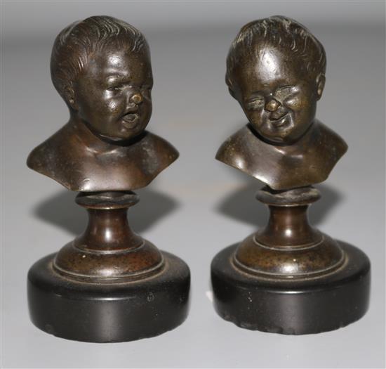 A pair of small bronze busts